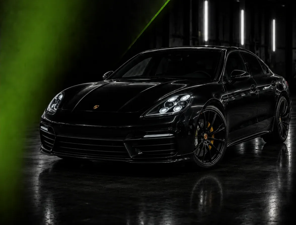 Black Porsche Panamera lit inside the Exotic Auto Services workshop in Mussafah, Abu Dhabi