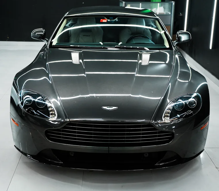 Grey Aston Martin Vantage photographed head-on after service at Exotic Auto Services, Mussafah.