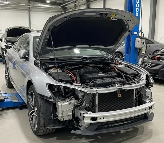 Flood-damaged luxury car being recovered at the Exotic Auto Services workshop in Mussafah, Abu Dhabi