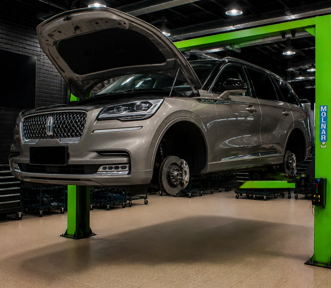 Lincoln raised on the two-post lift at the Exotic Auto Services workshop in Mussafah