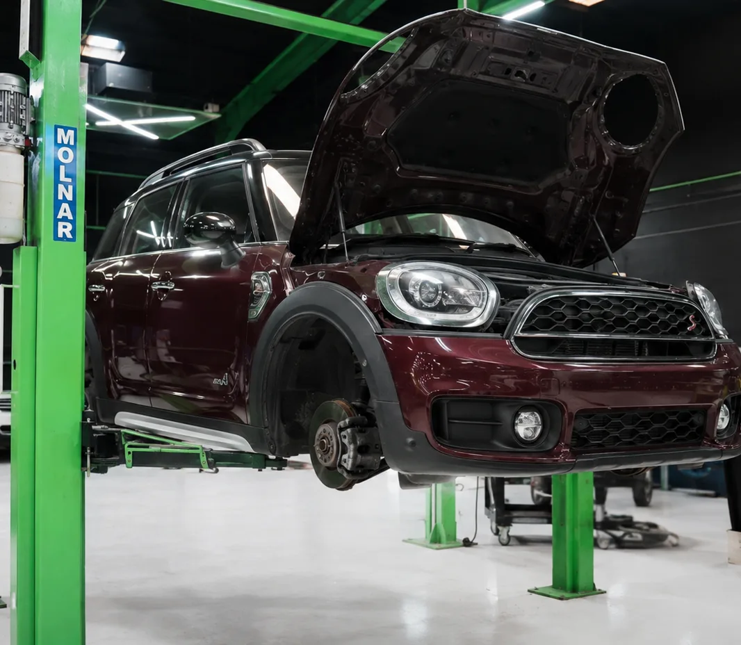 Mini Cooper raised on the two-post lift at the Exotic Auto Services workshop in Mussafah