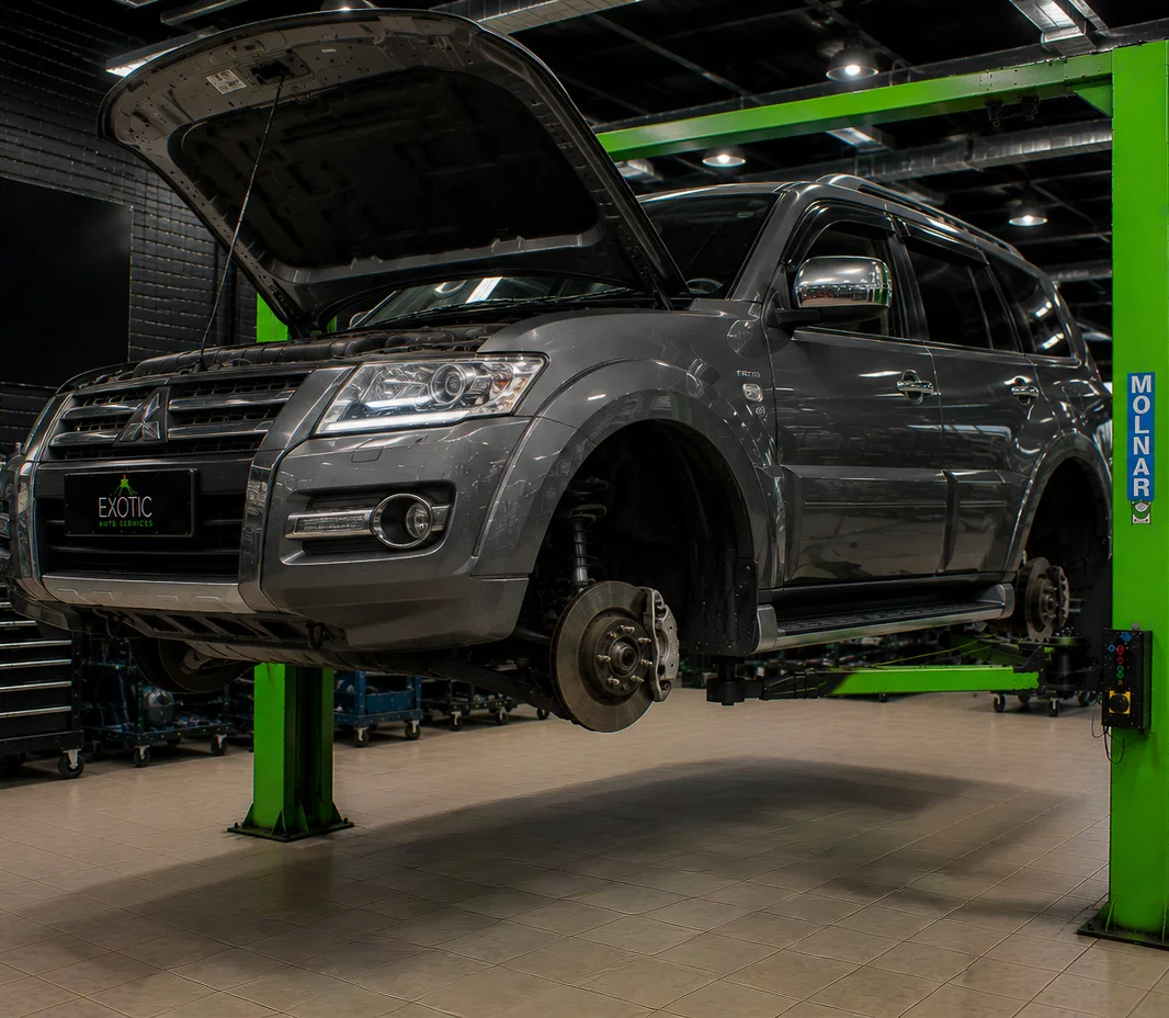 Mitsubishi with the wheels off for brake service at the Mussafah workshop
