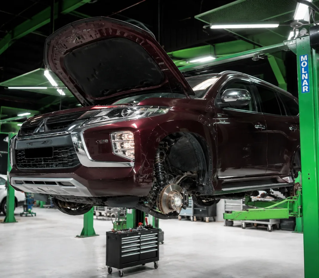 Mitsubishi raised on the two-post lift at the Exotic Auto Services workshop in Mussafah