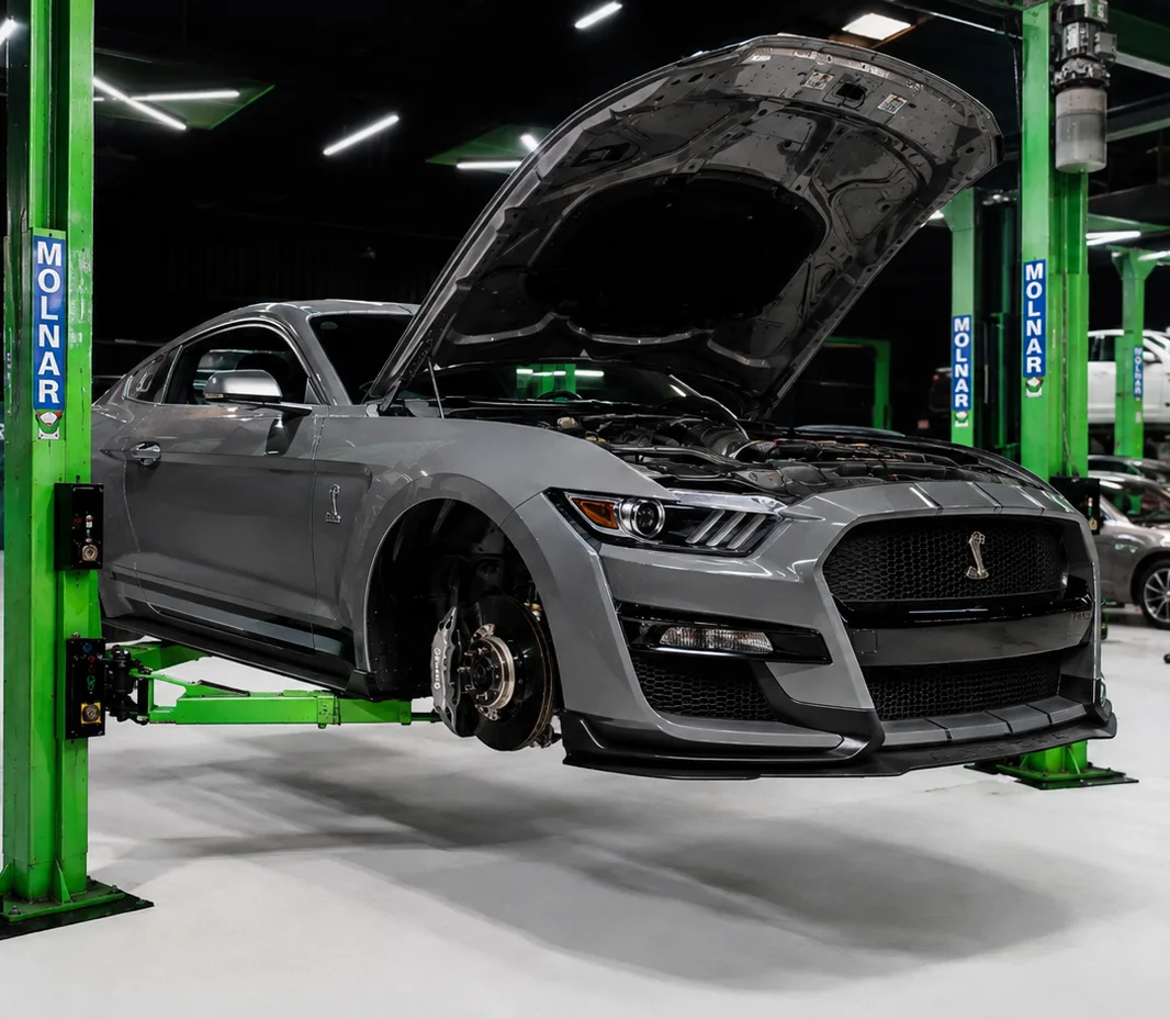 Mustang raised on the two-post lift at the Exotic Auto Services workshop in Mussafah