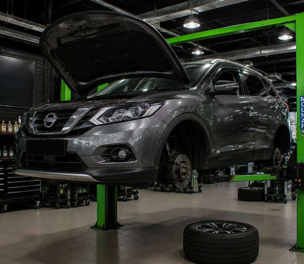 Nissan with the bonnet open for engine bay inspection in Mussafah, Abu Dhabi