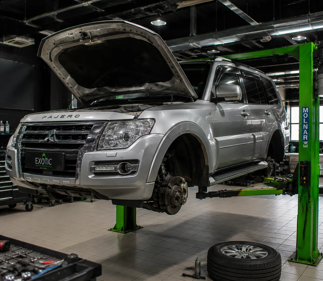 Pajero raised on the two-post lift at the Exotic Auto Services workshop in Mussafah