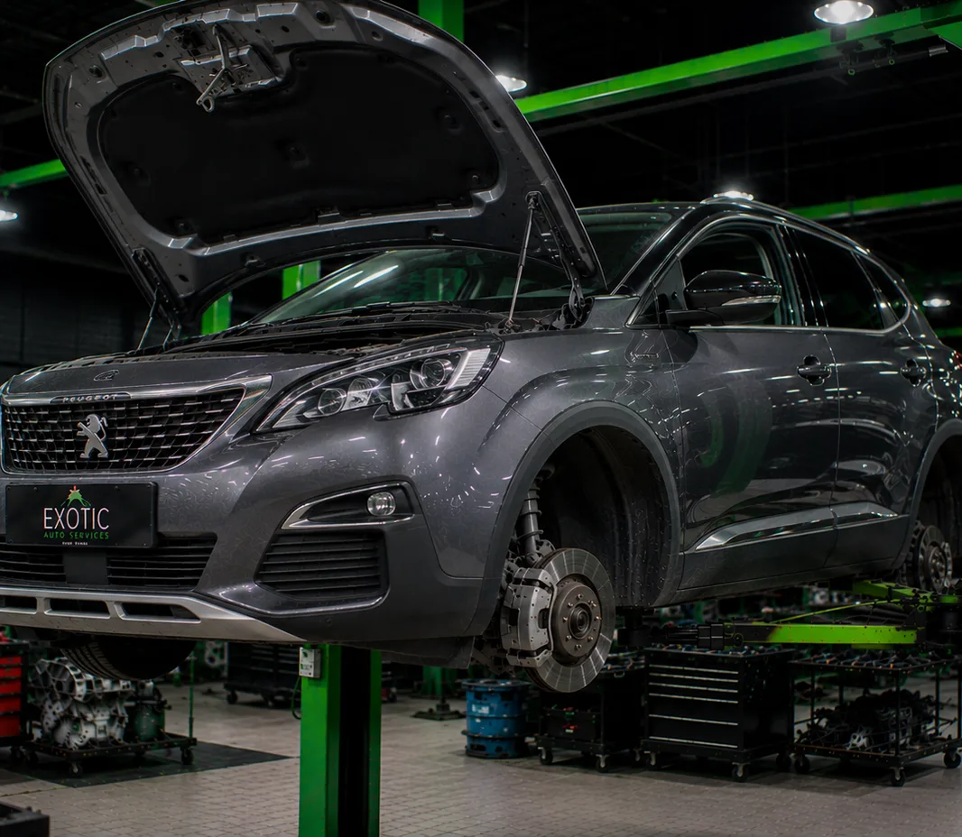Peugeot raised on the two-post lift at the Exotic Auto Services workshop in Mussafah