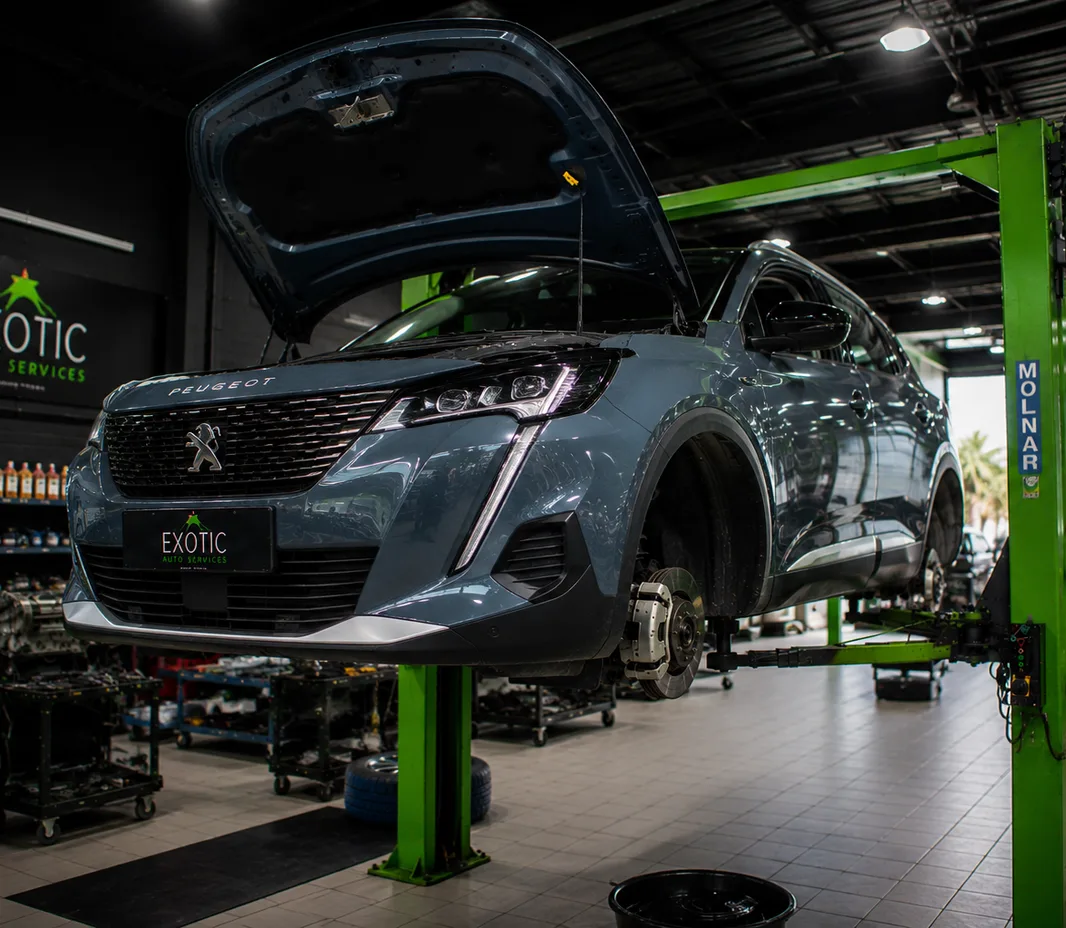 Peugeot on the ramp during suspension inspection in Abu Dhabi