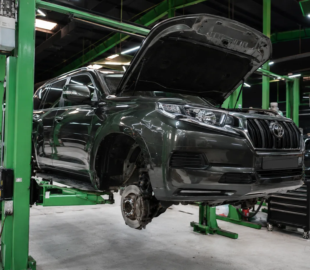 Prado raised on the two-post lift at the Exotic Auto Services workshop in Mussafah