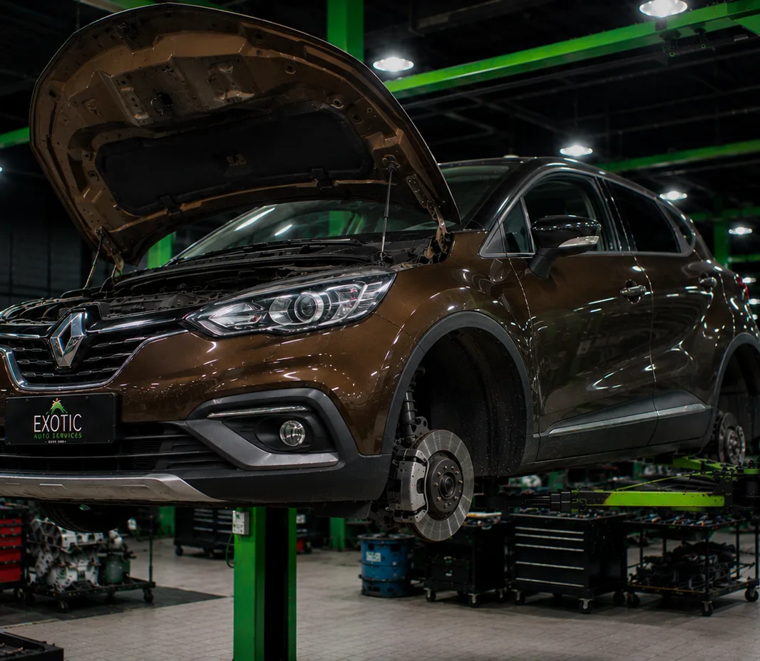 Renault with the wheels off for brake service at the Mussafah workshop