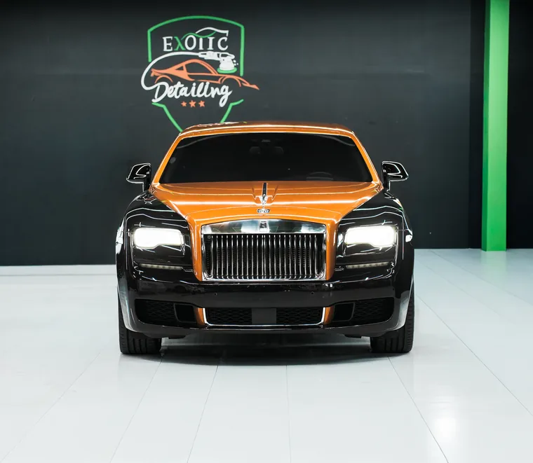 Close view of the grille and bonnet of a two-tone Rolls-Royce at the Exotic Auto Services workshop in Mussafah.