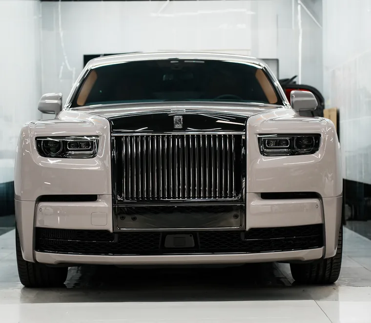 Cream Rolls-Royce Phantom photographed head-on in a service bay at the Exotic Auto Services workshop in Mussafah, Abu Dhabi.