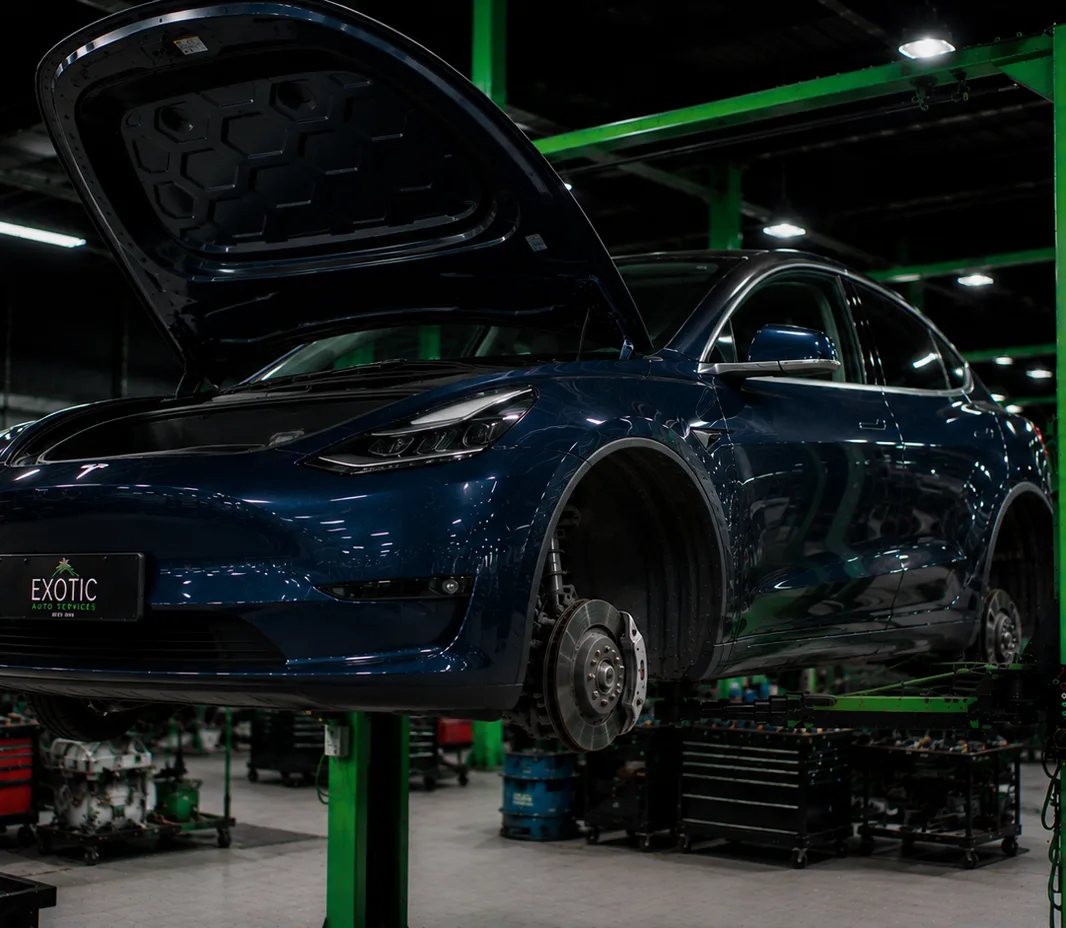 Tesla with the wheels off for brake service at the Mussafah workshop