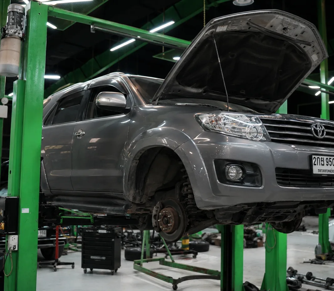 Toyota with the wheels off for brake service at the Mussafah workshop