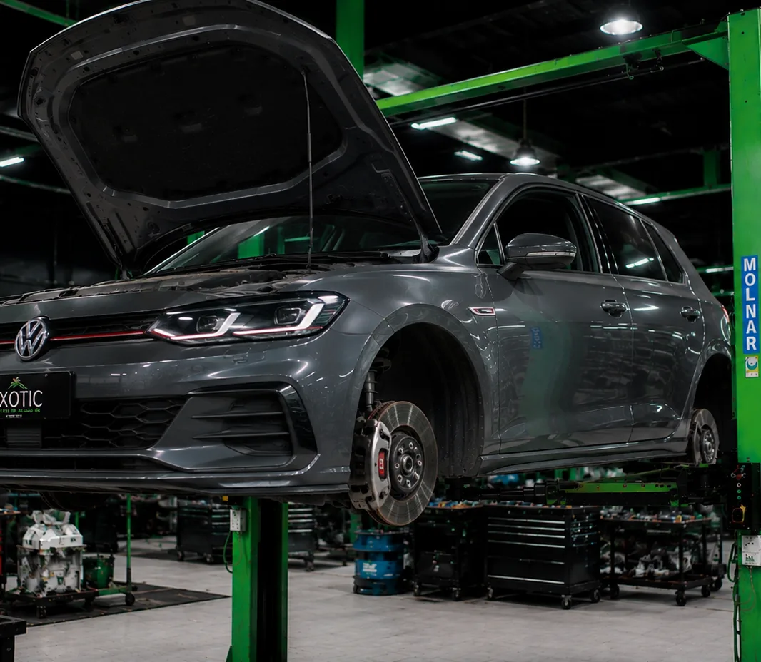 Volkswagen with the wheels off for brake service at the Mussafah workshop