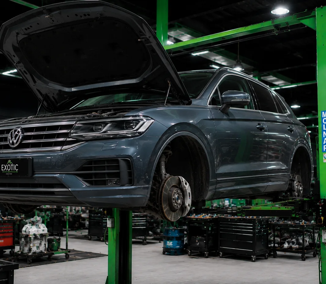 Volkswagen raised on the two-post lift at the Exotic Auto Services workshop in Mussafah